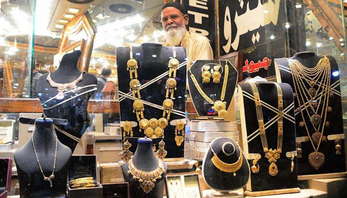 A shopkeeper waits for customers at his gold jewellery store in Hyderabads Resham Bazar on Nov 12, 2020. — APP/File