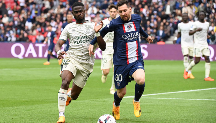 Paris Saint-Germains Argentine forward Lionel Messi (R) fights for the ball with Lorients Cameroonian defender Darlin Yongwa (L) during the French L1 football match between Paris Saint-Germain (PSG) and FC Lorient at The Parc des Princes Stadium in Paris on April 30, 2023. — AFP