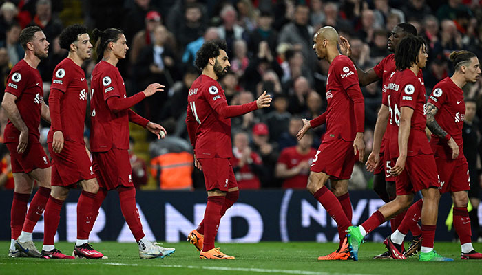 Liverpool´s Egyptian striker Mohamed Salah (C) celebrates after shooting a penalty kick and scoring his team first goal during the English Premier League football match between Liverpool and Fulham at Anfield in Liverpool, north west England on May 3, 2023.