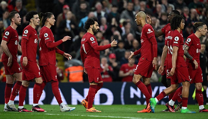 Liverpool´s Egyptian striker Mohamed Salah (C) celebrates after shooting a penalty kick and scoring his team first goal during the English Premier League football match between Liverpool and Fulham at Anfield in Liverpool, north west England on May 3, 2023.