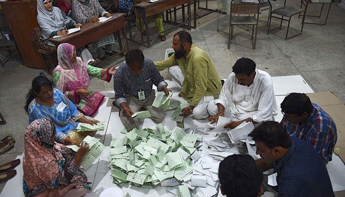 ECP officials counting votes at a polling station in Karachi. —AFP/File