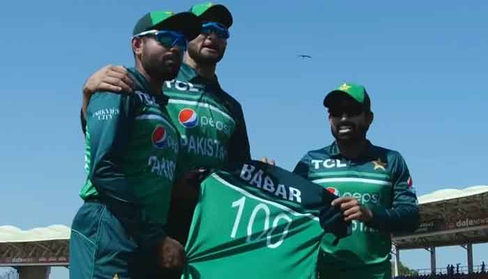 Babar Azam receives the shirt from teammates Mohammad Rizwan and Shaheen Shah Afridi. — PCB