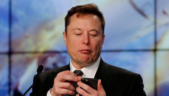 SpaceX founder and chief engineer Elon Musk looks at his mobile phone during a post-launch news conference at the Kennedy Space Center in Cape Canaveral, Florida, on 19, 2020.— Reuters