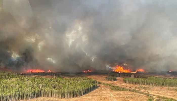 A smoke column rises from wildfire WWF023 near Fox Creek, Alberta, Canada May 5, 2023. — Reuters