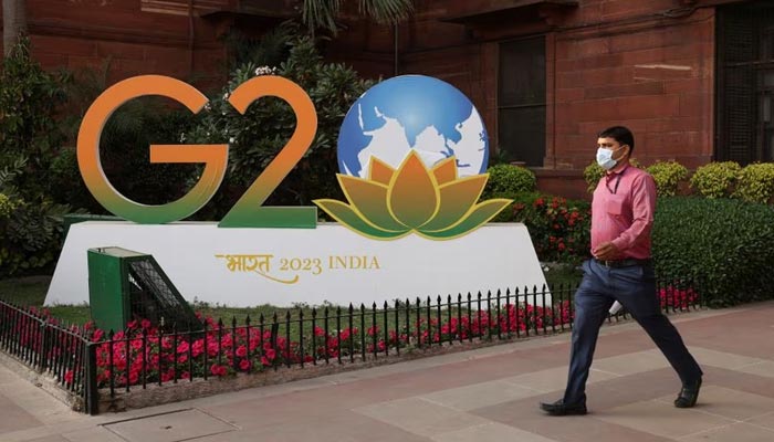 A man walks past a model of G20 logo outside the finance ministry in New Delhi, India, March 1, 2023. — Reuters