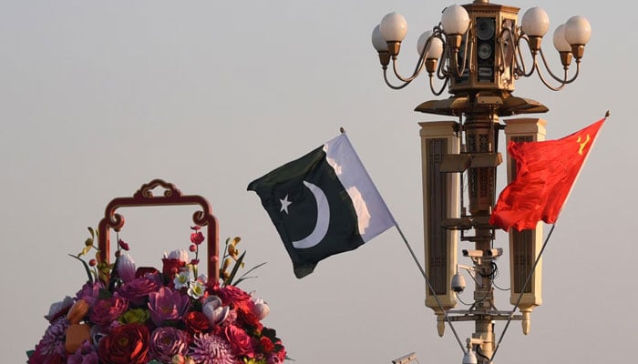 Pakistani and Chinese national flags flutter next to an installation featuring a giant flower basket at the Tiananmen Square in Beijing, China October 7, 2019. — Reuters/File