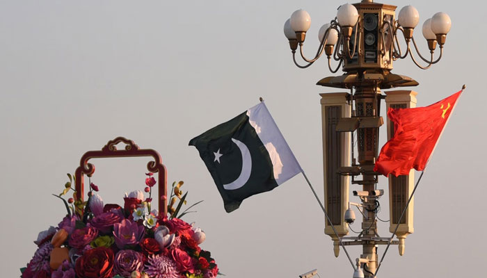 Pakistani and Chinese national flags flutter next to an installation featuring a giant flower basket at the Tiananmen Square in Beijing, China October 7, 2019. — Reuters/File