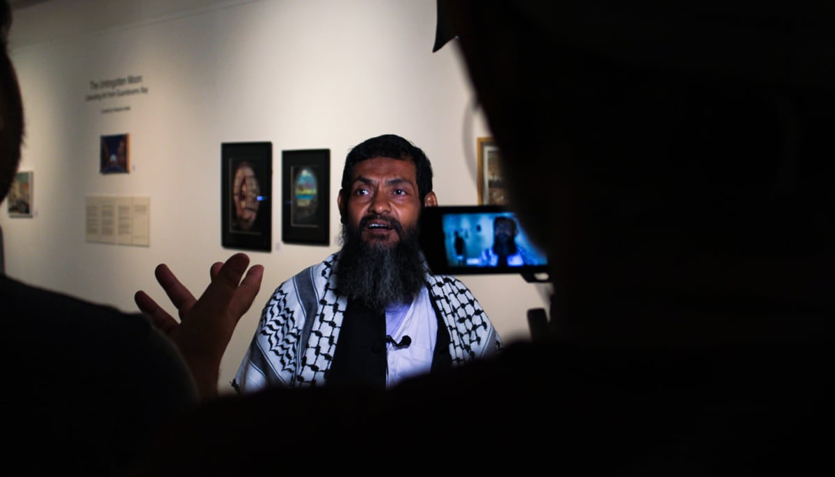 Ahmed talks to the media during his exhibition at the IVS gallery. — Photo by Hassaan Ahmed