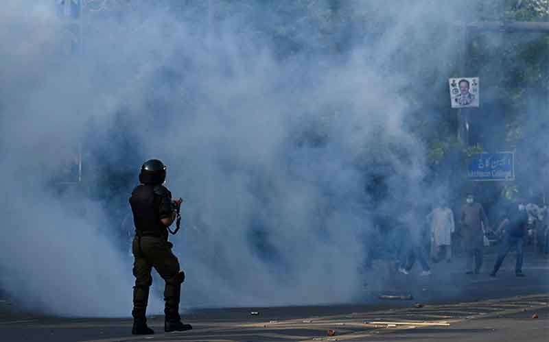 Police fire teargas shells towards Pakistan Tehreek-e-Insaf (PTI) party activist and supporters of former Pakistan´s Prime Minister Imran during a protest against the arrest of their leader in Lahore on May 9, 2023