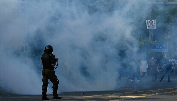 Police fire teargas shells towards PTI activists and supporters during a protest against the arrest of former prime minister Imran Khan. —AFP