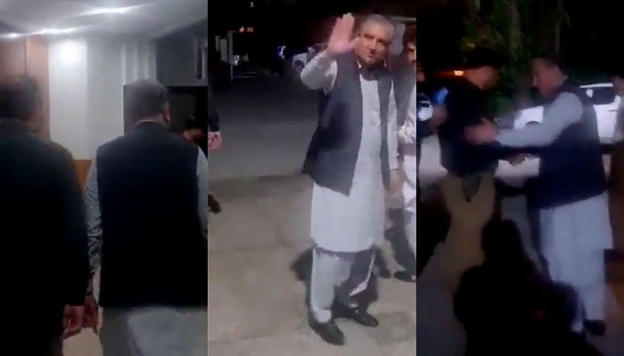 PTI Vice Chairman Shah Mahmood Qureshi waves at party workers and supporters when police takes him from Gilgit-Baltistan House, Islamabad on May 11, 2023, in this still taken from a video. — YouTube/PTIofficial