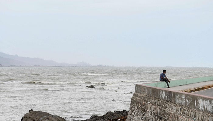 A man sits by the seafront in Sittwe in Myanmar’s Rakhine state on May 12, 2023, ahead of the expected arrival of Cyclone Mocha. Cyclone Mocha is forecast to make landfall on May 14 along the Bangladesh-Myanmar border, according to India´s meteorological office, packing winds of up to 175 kilometres (108 miles) per hour. —AFP