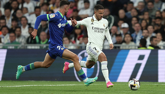 Getafes Spanish defender Juan Iglesias (L) vies with Real Madrids Belgian forward Eden Hazard during the Spanish league football match between Real Madrid CF and Getafe CF at the Santiago Bernabeu stadium in Madrid on May 13, 2023. AFP