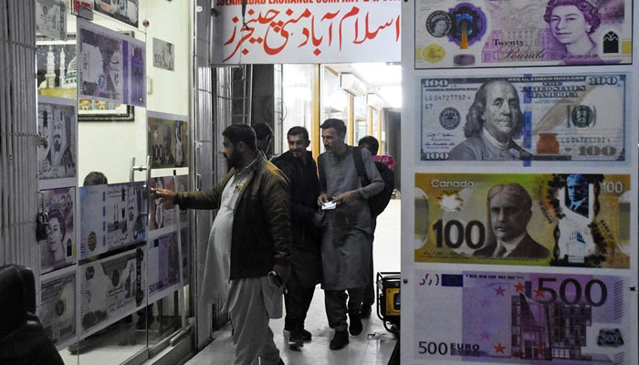 People are entering in a money changer shop in blue area in Islamabad on January 26, 2023. — Online