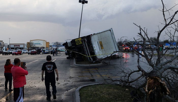 People look at an overturned truck in a parking lot after a tornado in a widespread storm system touched down in Round Rock, Texas, US. — Reuters