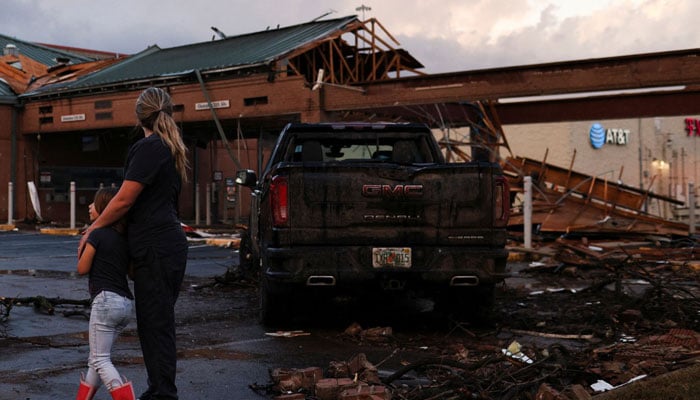 People survey the damage to a shopping centre after a tornado in a widespread storm system touched down in Round Rock, Texas, US. — Reuters