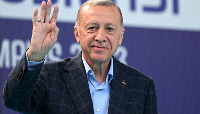 Turkish President Recep Tayyip Erdogan waves to supporters prior to address a speech at a rally in the Beyoglu district on the eve of the presidential and parliamentary elections, on the European side of Istanbul, on May 13, 2023. — AFP