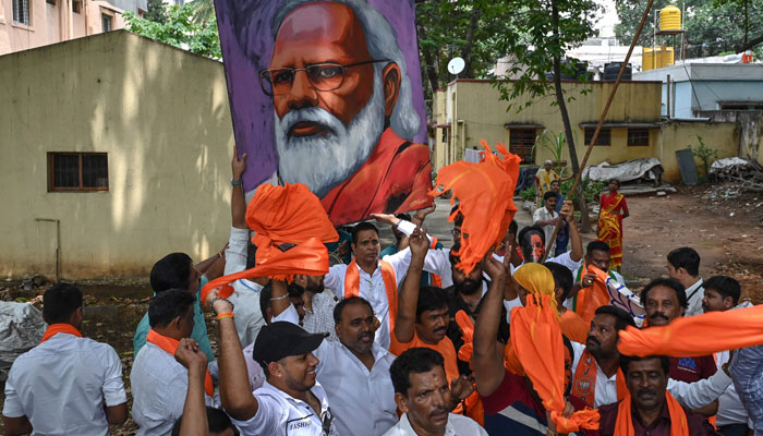 Bharatiya Janata Party (BJP) workers and activists carry a portrait of Indian Prime Minister Narendra Modi as they wait to see Modi during a road rally held by the BJP in Bengaluru. — AFP/File