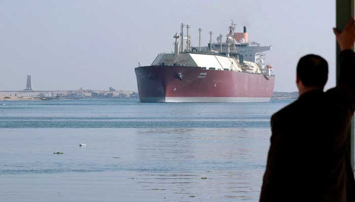 An Egyptian man looks at the Qatari Liquefied Natural Gas (LNG) carrier Duhail as its passes through the Suez Canal near the Egyptian port city of Ismailia on April 1, 2008. — AFP