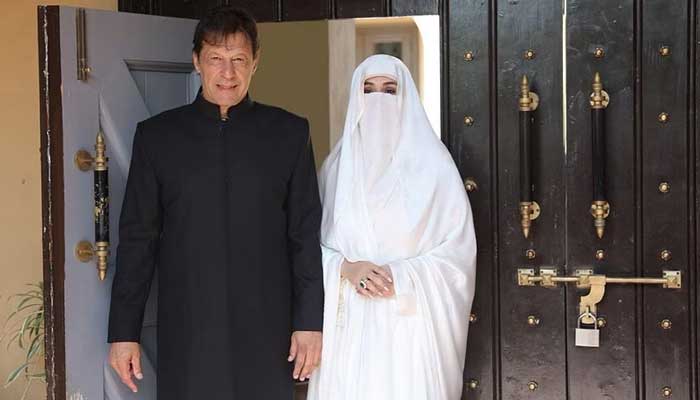 Prime Minister Imran Khan (left) with his wife Bushra Bibi. — Twitter/@PTIofficial