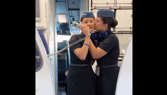 An air hostess kisses her co-workers daughter as the latter makes a special announcement for the former on Mother’s Day during a flight. — Twitter/IndiGo6E