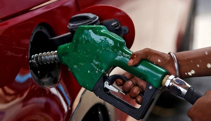 A petrol pump worker fills the tank of a car in this undated photo. — Reuters/File