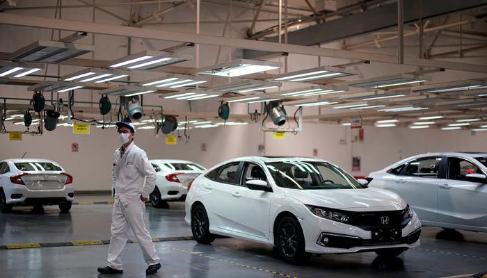An employee is seen on a production line inside a Dongfeng Honda factory, April 8, 2020.