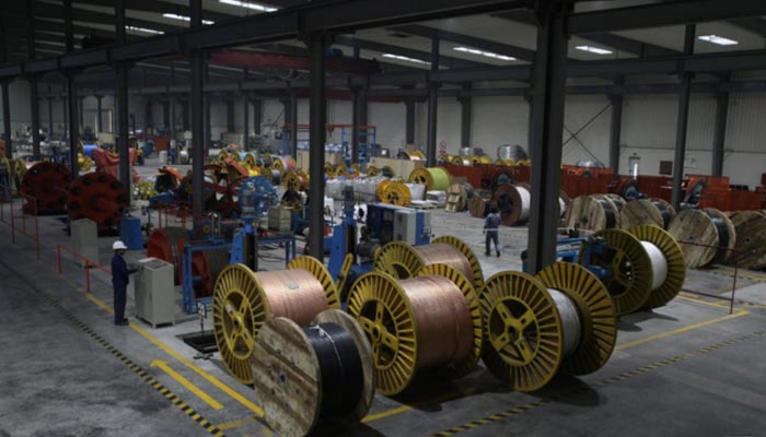 A worker monitors automatic copper wire unit at the Fast Cables plant in Lahore, Pakistan, March 24, 2017. — Reuters