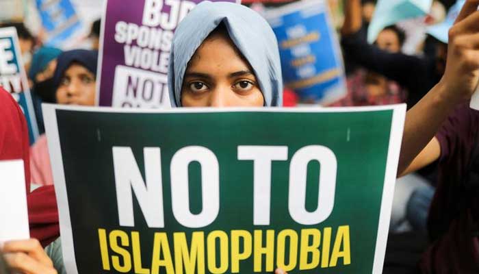 A citizen holds a placard during a peace vigil organised by citizens against what they say is rise in hate crimes and violence against Muslims in the country, in New Delhi, India, April 16, 2022. — Reuters