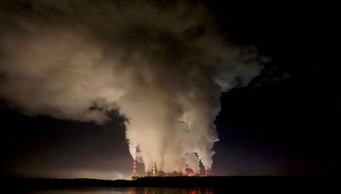 Smoke and steam billow from Belchatow Power Station, Europes largest coal-fired power plant, operated by PGE Group, at night near Belchatow, Poland. — Reuters/File