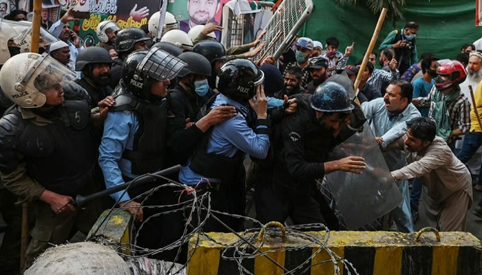 Riot police clash with unarmed supporters of Pakistan’s former prime minister Imran Khan outside his house in Lahore on Tuesday. AFP/File