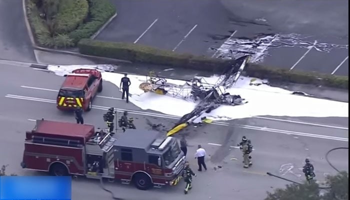 A screengrab shows a banner plane wreck where the personnel of the fire department can also be seen at the crash site on May 17, 2023. — CBS Miami