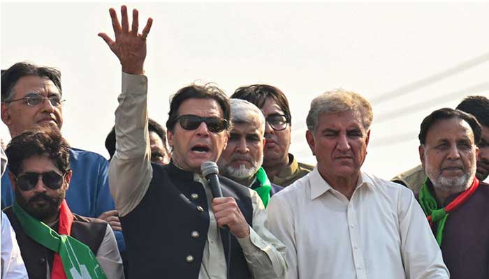 PTI Chairman Imran Khan addresses his supporters during an anti-government long march towards Islamabad to demand early elections, in Lahore on October 29, 2022. — AFP