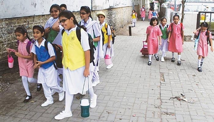 In the photo, students walk to their school.  — Online/File