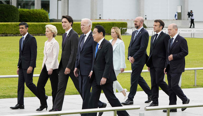 (L-R) British PM Rishi Sunak, European Commission President Ursula von der Leyen, Canadian PM Justin Trudeau, US President Biden, Japans PM Fumio Kishida, Italian PM Giorgia Meloni, European Council President Charles Michel, French President Macron, German Chancellor Scholz walk to a flower wreath-laying ceremony at Peace Memorial Park in Hiroshima on May 19, 2023. — AFP