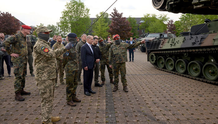 This photograph on May 14, 2023, shows German Chancellor Olaf Scholz (C-L) and Ukrainian President Volodymyr Zelensky (C-R) visiting a military base in Aachen, western Germany. — AFP