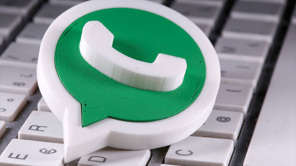 A 3D printed Whatsapp logo is placed on the keyboard in this illustration taken April 12, 2020.
