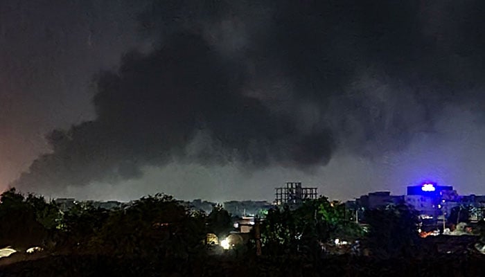 Smoke rises above buildings in Khartoum on May 19, 2023, as violence between two rival Sudanese generals continues. About half a million people have fled Khartoum since fighting broke out in mid-April with shelling and air strikes continuing on a daily basis. —AFP