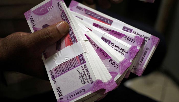 A cashier displays the new 2000 Indian rupee banknotes inside a bank in Jammu, November 15, 2016. — Reuters