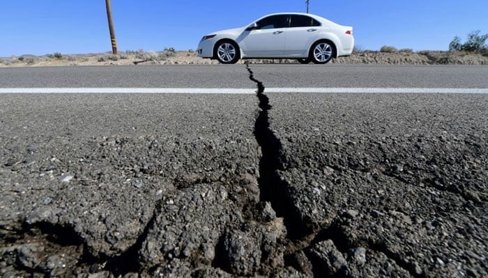 A car drives past a crack in the road on Highway 178, south of Trona, California, after a 6.4-magnitude earthquake hit the south of the state. —AFP/file