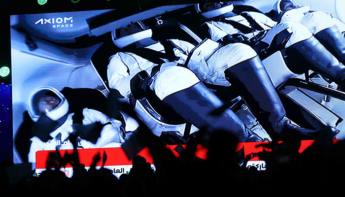 People watch a screen in Riyadh on May 21, 2023, as a SpaceX Falcon 9 rocket carrying the Axiom Mission 2 astronauts prepares to lift off from pad 39A at NASA´s Kennedy Space Center in Florida. Two Saudi astronauts, including the first Saudi woman, will blast off from Florida on May 21 on a private mission to the International Space Station (ISS). —AFP