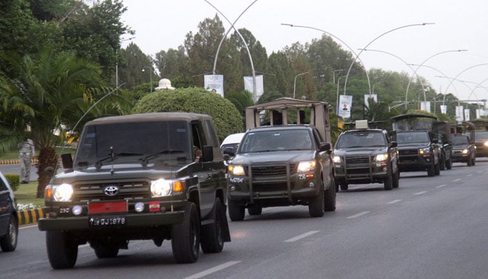 Pakistan Army vehicles patrol during a flag march, ahead of former prime minister Imran Khans appearance in the Supreme Court in Islamabad, Pakistan May 11, 2023. — Reuters.