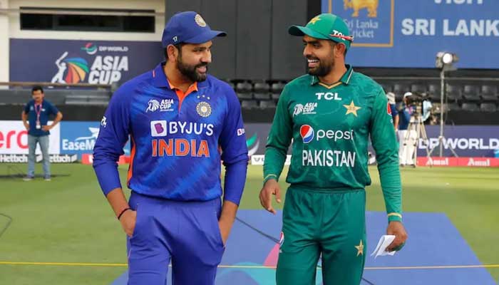 Indian captain Rohit Sharma (left) and Pakistan skipper Babar Azam walk out for the toss during the Asia Cup in Dubai, United Arab Emirates on September 4, 2022. — ACC