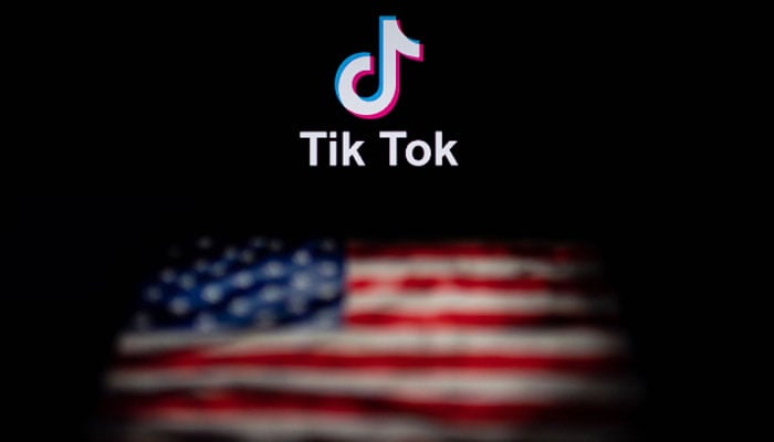 This illustration shows the logo of the social network application TikTok (top) and a US flag (bottom). — AFP/File