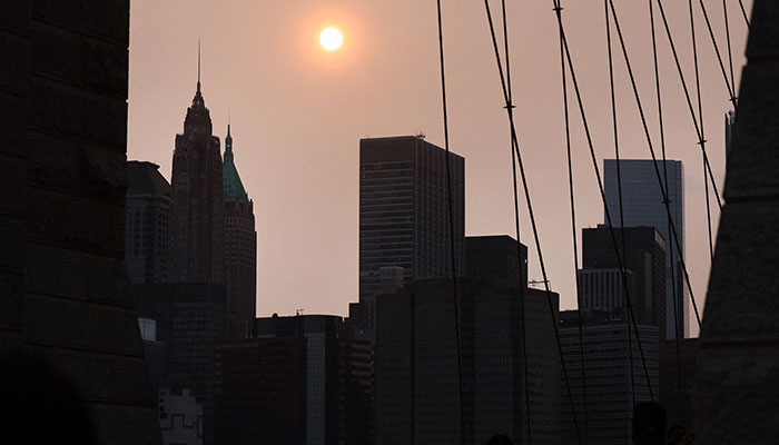 A hazy sun sets in New York City on May 22, 2023. The National Weather Service has said that haze from the Canadian wildfires some 3,000 miles away is impacting New York City and much of the Northeast.—AFP