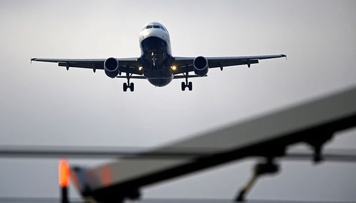 An aeroplane prepares to land at Cointrin airport in Geneva, Switzerland December 5, 2017. — Reuters