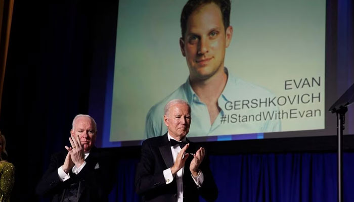 US President Joe Biden applauds, as an image of Wall Street Journal reporter Evan Gershkovich, who was detained in Russia in March and charged with espionage, is displayed, during the annual White House Correspondents Association Dinner in Washington, US, April 29, 2023.—Reuters