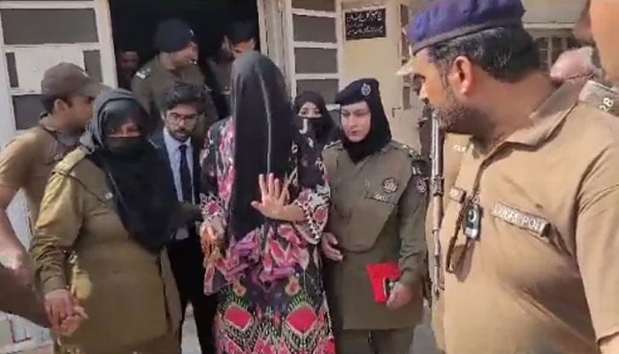 PTI supporter Khadija Shah being taken by police from the court room. — Screengrab/Geo News