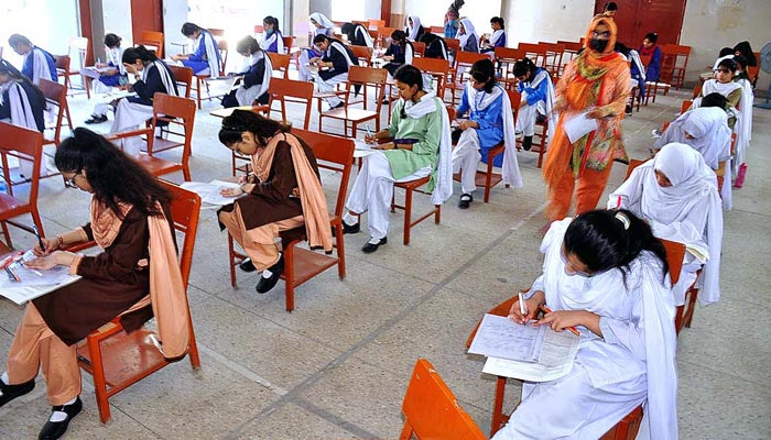 Students solving papers during the ninth class exams in Karachi on May 9, 2023. — APP