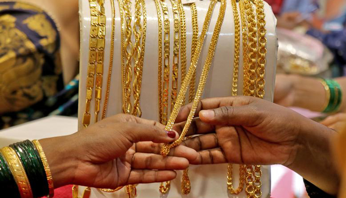 Customers check ornaments at a jewellery showroom during Dhanteras, a Hindu festival associated with Lakshmi, the goddess of wealth, in Mumbai, India on November 2, 2021. — Reuters
